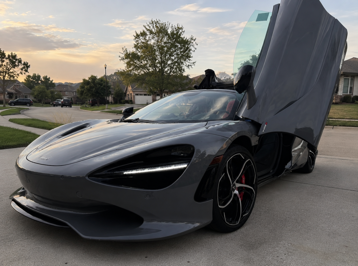 McLaren 720S Spider with dihedral door open at sunset after a premium detail